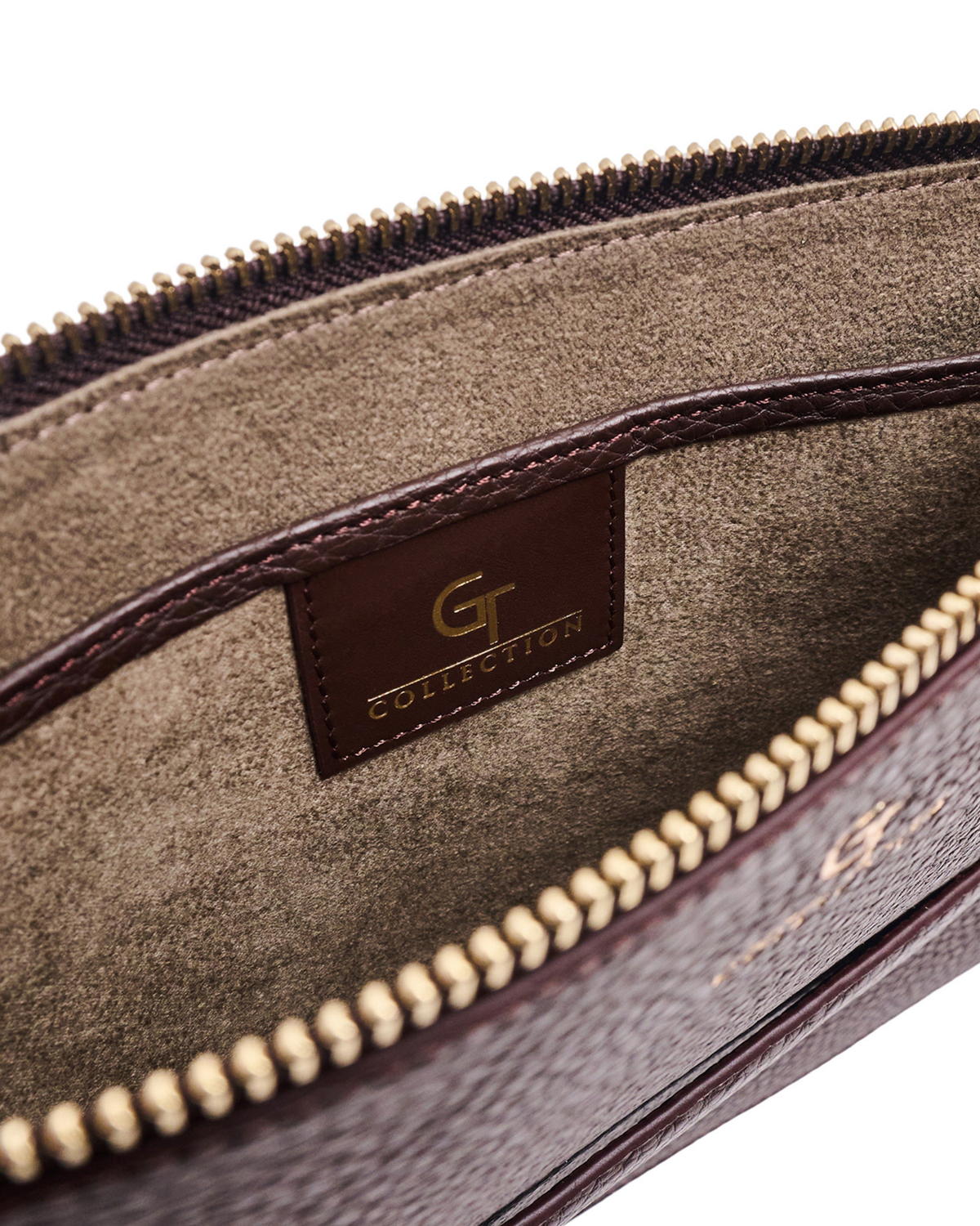 Brown leather pouch interior with gold zipper teeth and Collection tag