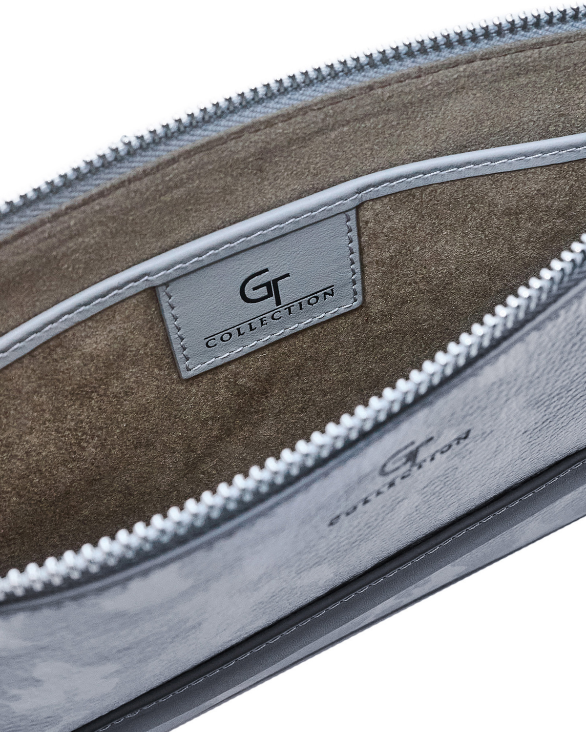 Inside view of camo leather pouch with suede lining, logo patch, and zipper