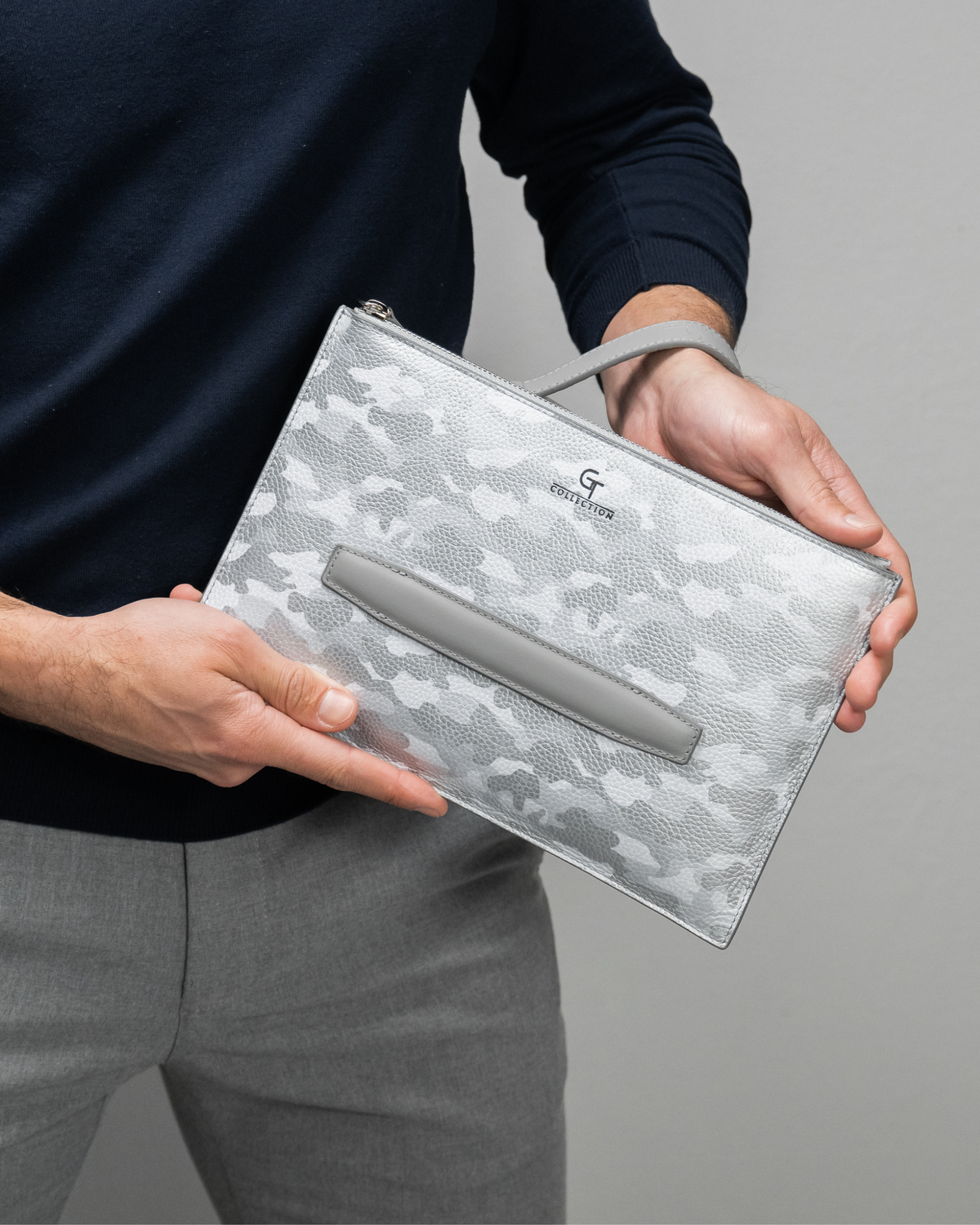 Silver camo leather wrist pouch with zip closure and embossed logo panel