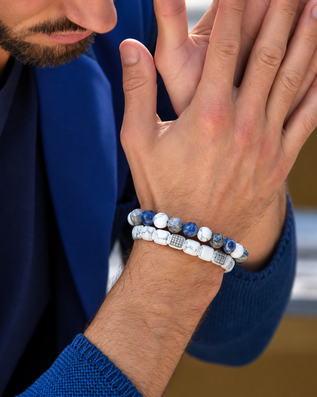 Blue and white beaded bracelet on wrist with round stone beads and elastic fit