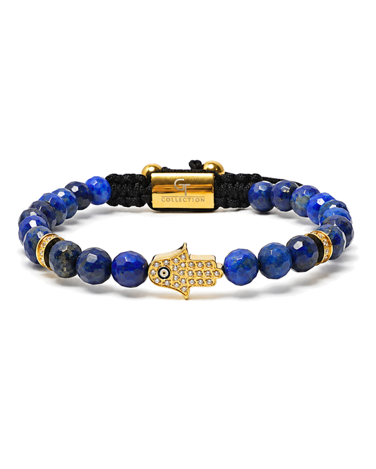 Blue lapis bead bracelet with gold hamsa pendant, black cord center bar, gold details.