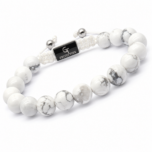 White howlite bead bracelet with G Collection tag and silver cord ends, side view