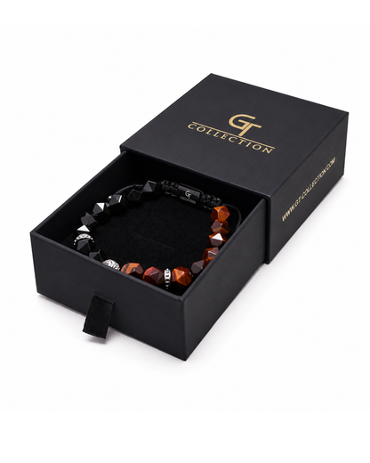 Lion beaded bracelet in black presentation box with orange-brown and black stones.