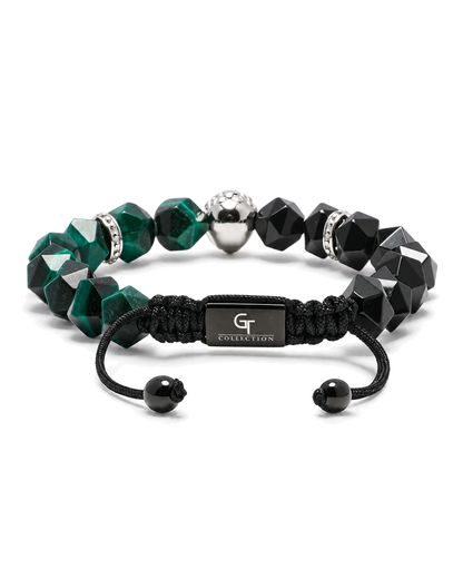 Cord bracelet with black faceted beads, green stones, and silver-tone lion charm centerpiece.