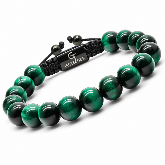 Green tiger eye beaded bracelet with black cord and metal tag, flat lay