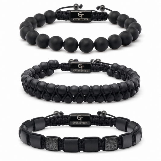 Three black bracelets: matte bead, braided cord, and leather strap with studs