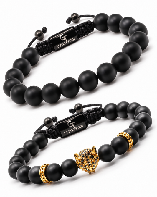 Black beaded bracelet stack with gold-toned accents and charm