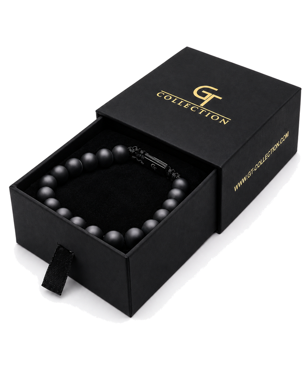 Black beaded bracelet laid in a gift box