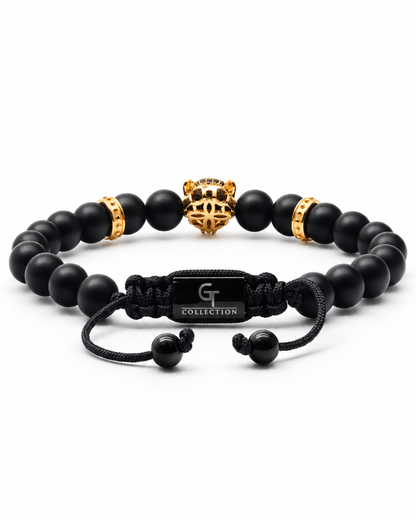 Black beaded bracelet with gold leopard charm, gold spacers, and black cord clasp